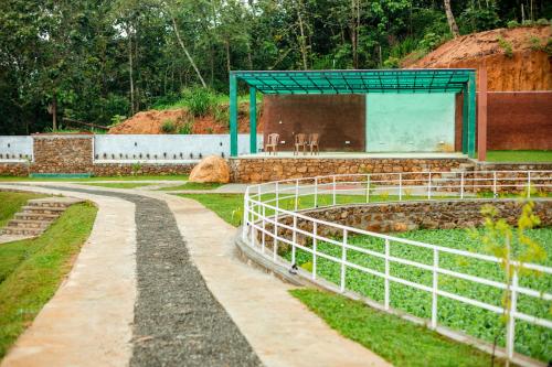 a garden with a building in the middle of it at Capital Resort Inn in Monaragala