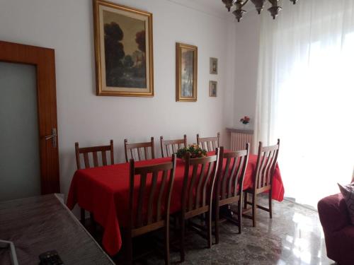a dining room with a table with a red table cloth at La Casa del Corso in Alberobello