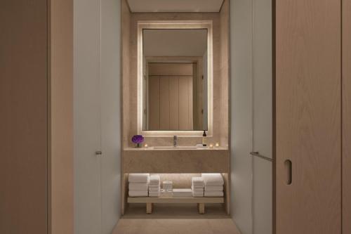 a bathroom with a sink and a mirror at The Jeddah EDITION in Jeddah