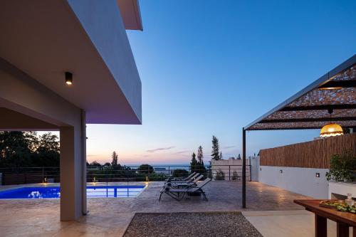 a house with a view of a swimming pool at Rousso Villa in Roussospítion