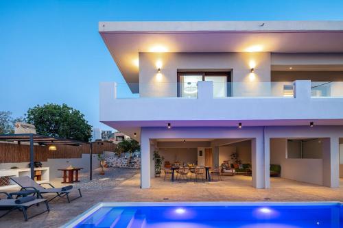 a view of a house with a swimming pool at Rousso Villa in Roussospítion