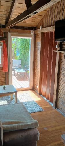 a living room with a large sliding glass door at Domeczek Sami in Łunowo