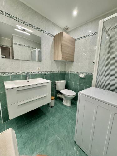 une salle de bain avec un lavabo blanc et des toilettes dans l'établissement Grand Studio au Coeur de la Vieille Ville Clim, à Menton