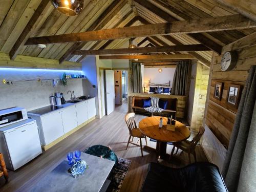 a kitchen and dining room with a table in a room at Ard Veich Estate - Panoramic Highland Sea Views with private beach and woodland in Port Appin