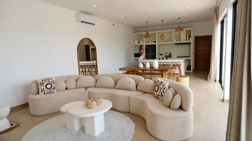 a living room with a couch and a table at Villa YAOUH à Seseh in Munggu