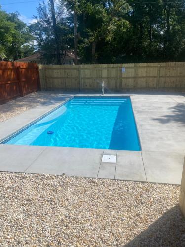 a swimming pool in a backyard with a fence at Beach Lovin/sleeps 10/2 blocks to beach/pets ok in Myrtle Beach