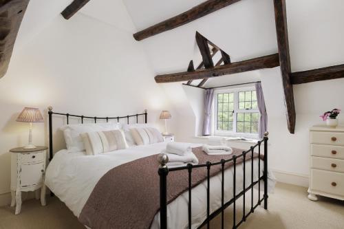 En eller flere senge i et værelse på Grange Cottage