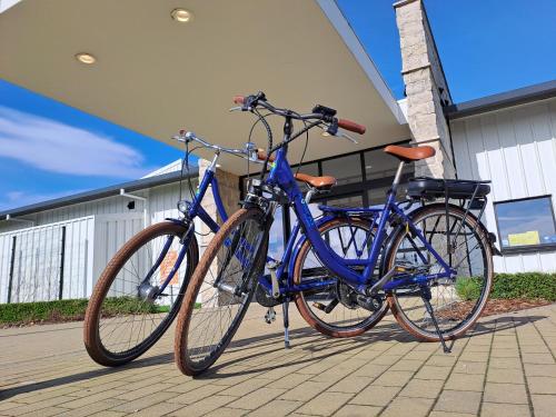 two bikes parked next to each other on a sidewalk at Kompas Camping Nieuwpoort in Nieuwpoort