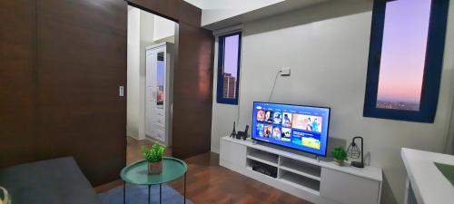 a living room with a flat screen tv on a wall at Air Residences great location in Makati CBD in Manila