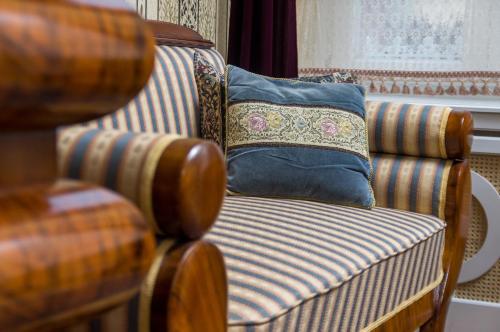 a striped chair with a pillow on top of it at Vila Katharina in Braşov