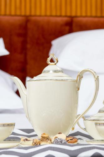 a white tea pot sitting on a table at Vila Katharina in Braşov