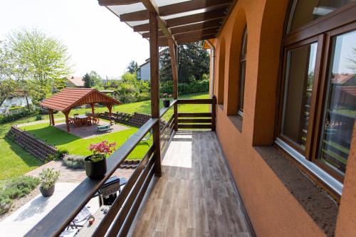 a balcony of a house with a gazebo at Kulcsi-Duna Vendégház in Kulcs