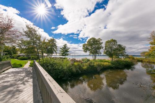 a bridge over a river with the sun in the sky at The Shores in Williamsburg