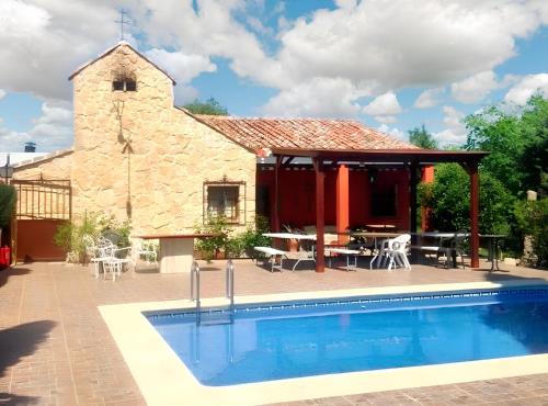a church with a swimming pool in front of a building at 6 bedrooms house with private pool and enclosed garden at Burguillos de Toledo in Burguillos de Toledo