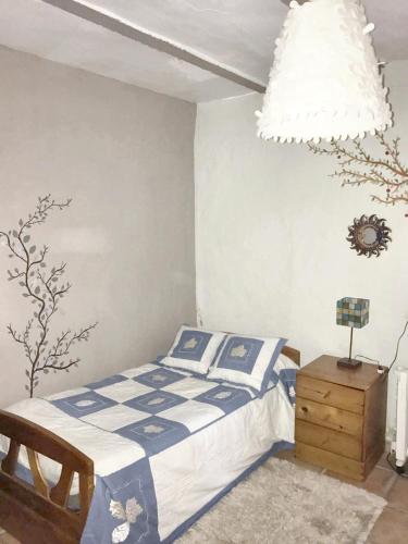 a bedroom with a bed and a chandelier at 6 bedrooms house with private pool and enclosed garden at Burguillos de Toledo in Burguillos de Toledo