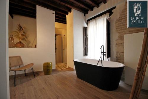a bathroom with a large bath tub in a room at Patio de los Ángeles in Toledo