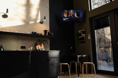 a kitchen with a counter and stools in a room at Domek SzumiSosna1 in Raków