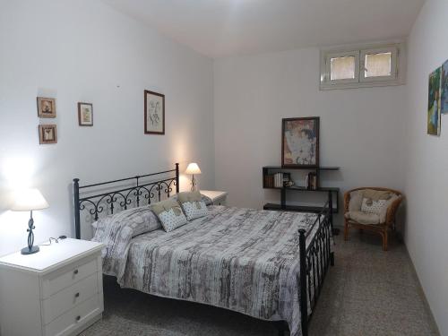 a bedroom with a bed and a desk and a chair at CASA JUANNE iun P2043 in Galtellì