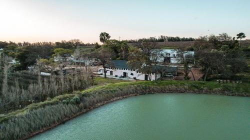 an aerial view of a house next to a river at Le Héritage in Klein-Drakenstein