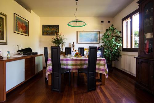 a dining room with a table with chairs at Al Parco Storga B&b in Treviso