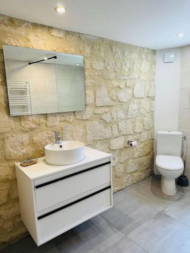 a bathroom with a sink and a toilet at Demeure rénovée front de mer in Courseulles-sur-Mer