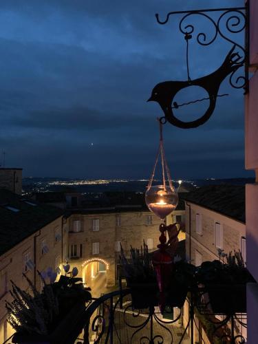 a light on a balcony with a bird on a hook at Vecchio Calzaturificio Verducci in Montegranaro