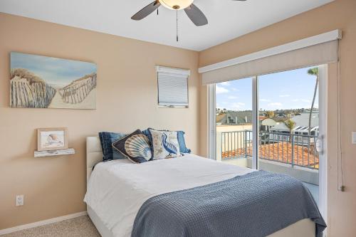a bedroom with a bed and a large window at Brighton Adventure in San Diego