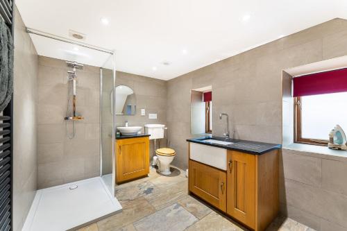 a bathroom with a shower and a sink and a toilet at Old Farmhouse in Hawkshead