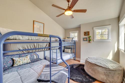 a room with two bunk beds and a ceiling fan at Donnelly Cabin with Hot Tub Less Than 1 Mi to Boulder Creek! in Donnelly