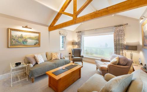 a living room with a couch and a table at Orchard Mount in Troutbeck