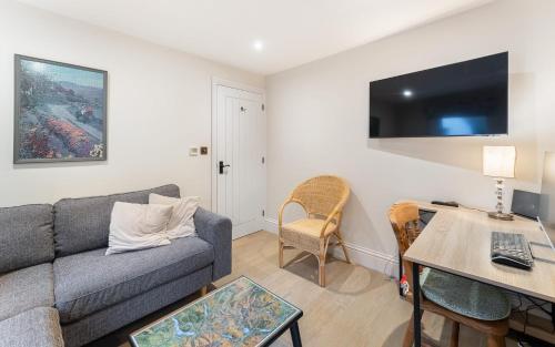 a living room with a couch and a table at Orchard Mount in Troutbeck