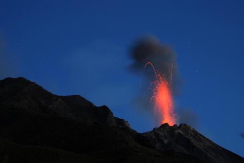 a volcano emits lava in the sky at night at Villa Mareblu Luxury Holiday Apartment direttamente sul mare in Stromboli