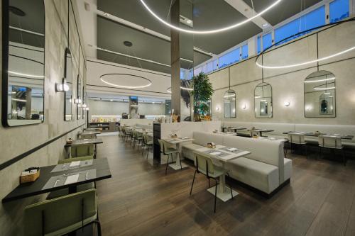 - un restaurant avec des tables et des chaises dans une salle dans l'établissement 1881 Madrid Ventas Hotel, à Madrid