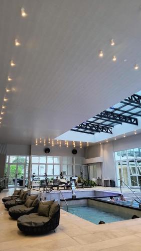 a large lobby with a swimming pool and couches at HDA Hotel & Spa in Termas de Río Hondo