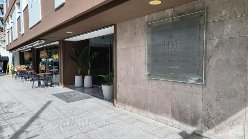 a building with a sign on the side of it at HDA Hotel & Spa in Termas de Río Hondo