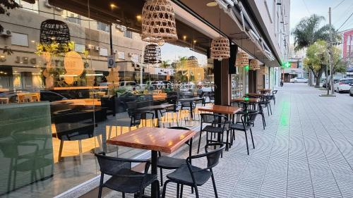 a restaurant with tables and chairs on a sidewalk at HDA Hotel & Spa in Termas de Río Hondo