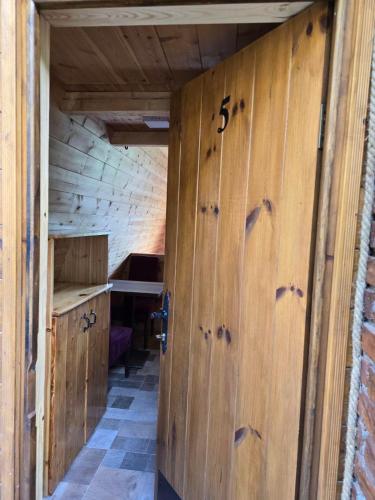 an empty room with wooden doors in a kitchen at Peaks of Prokletije - Outdoor pool in Gusinje