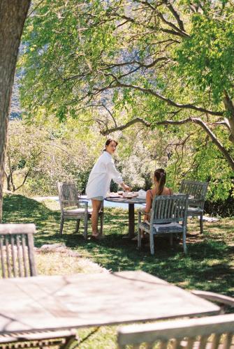 two people sitting at a picnic table in a park at Agroturismo Son Viscos in Valldemossa