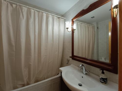 a white bathroom with a sink and a mirror at Inmocyma La terraceta de Linsoles-Valle de Benasque in Benasque