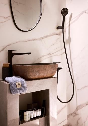 a bathroom with a tub and a sink and a mirror at Luxury White House - Villa & Weddings - Family Villa Near the Sea to the Famous Zorbas Beach in Stavros