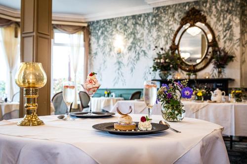 a table with a plate of food on it at Fernhill House Hotel & Gardens in Clonakilty