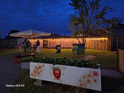 a garden with a table and a fence with lights at Casa Matilde in Leinì