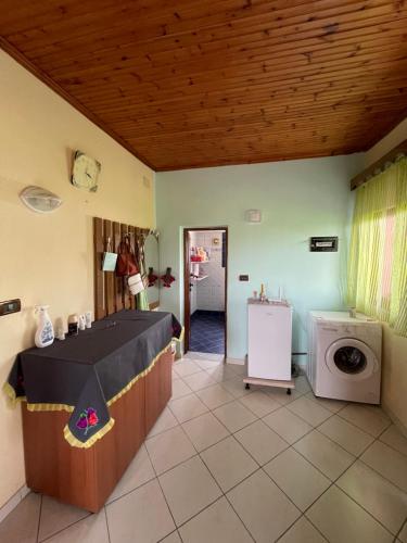 a laundry room with a table and a washing machine at Villa Mance in Berat