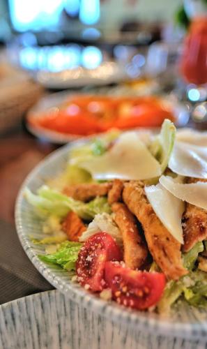 a plate of food with chicken and vegetables on a table at Burki Castle & Cellar in Kvareli