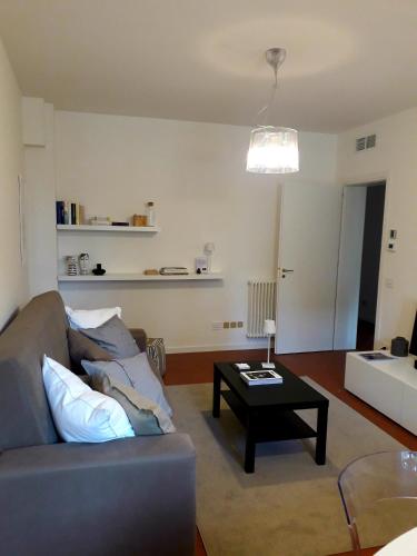 a living room with a couch and a coffee table at La casa del Vescovo in Imola