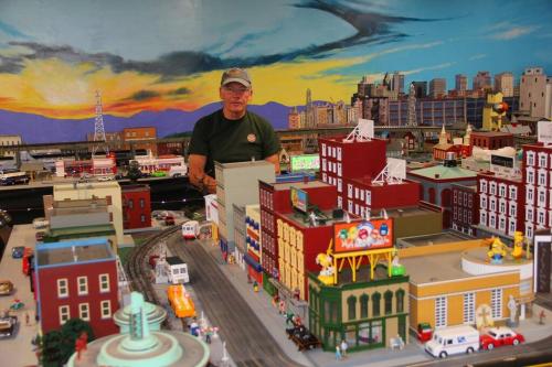 a man standing next to a model of a city at Seaboard Coastline #0887: Sleep in a caboose on a bison ranch in Clyde