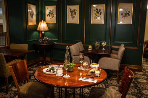 a dining room with a table and chairs at Fernhill House Hotel & Gardens in Clonakilty