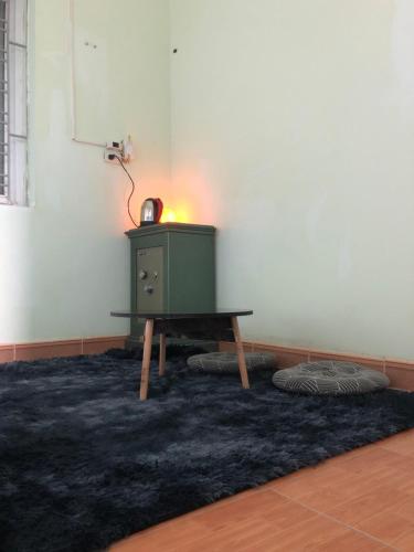 a green cabinet in a room with a table at Bee Hostel in Ha Long