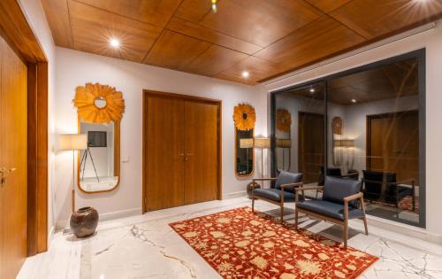 a living room with two chairs and a table at Amorzito by Solitaire Stays in Marmagao