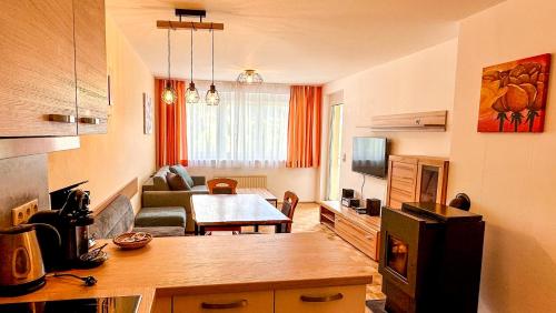 a kitchen and living room with a couch and a table at Apartments Bergblick in Sonnenalpe Nassfeld
